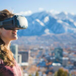 A woman wearing a VR headset stands outside in Salt Lake City